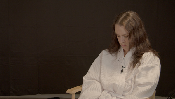 Rosalee in a robe during her erotic hypnosis session.